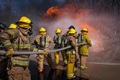 Group of firefighters putting out fire